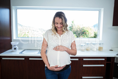 Pregnant woman touching belly