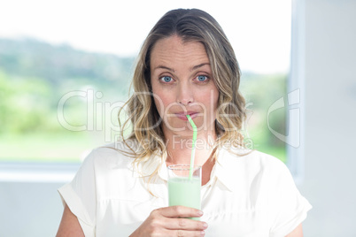 Pregnant woman drinking a smoothie