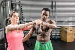 Fit couple lifting dumbbells