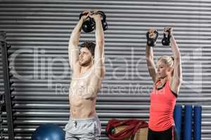 Couple lifting dumbbells together