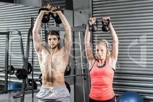 Couple lifting dumbbells together