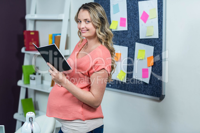 Pregnant woman reading a notebook