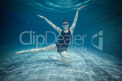 Pretty woman stretching underwater