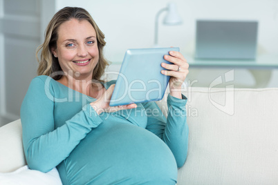 Pregnant woman using a tablet computer