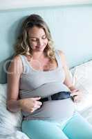 Pregnant woman making her belly listen to music