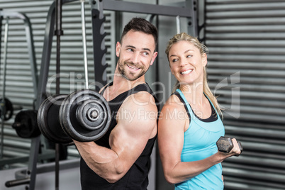 Couple posing with dumbbells