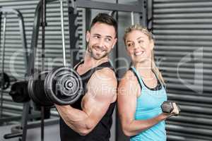 Couple posing with dumbbells