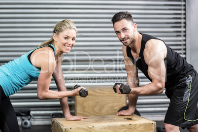 Couple lifting dumbbells together