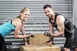 Couple lifting dumbbells together