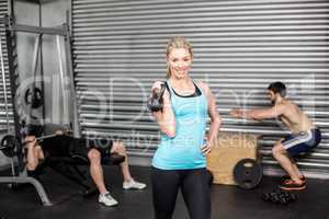Woman posing with dumbbells
