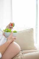 Pregnant woman eating salad