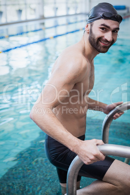 Fit man getting out of the water