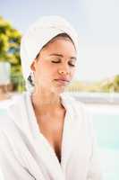 Peaceful brunette with closed eyes wearing white towel