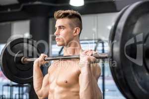 Fit man lifting barbell