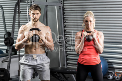 Couple lifting dumbbells together