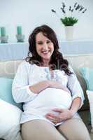 Pregnant woman sitting in the living room