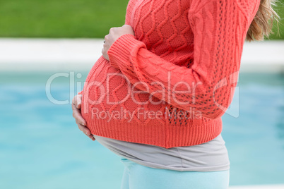 Pregnant woman touching her belly