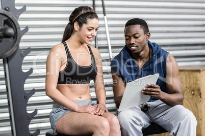 Athletic woman and trainer smiling to camera
