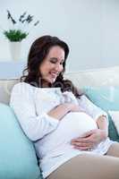 Pregnant woman sitting in the living room