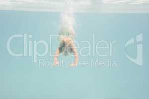 Fit woman swimming under water