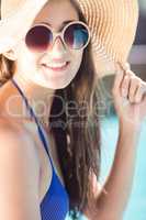 Smiling brunette with hat and sunglasses