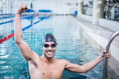 Handsome man triumphing with raised arms