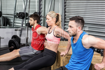 Fit people doing exercises with box