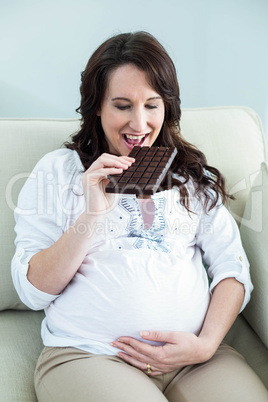 Pregnant woman eating chocolate