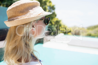 Beautiful blonde looking at the pool