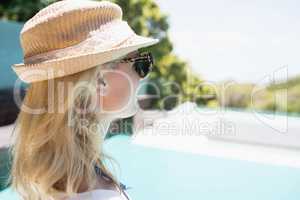 Beautiful blonde looking at the pool