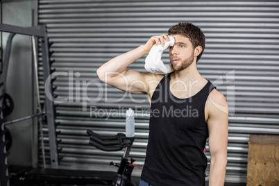 Fit man wiping his face with towel