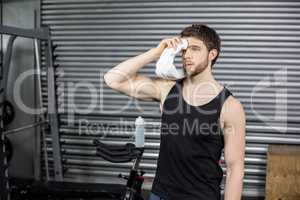 Fit man wiping his face with towel