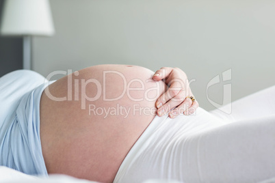 Pregnant woman resting on her bed