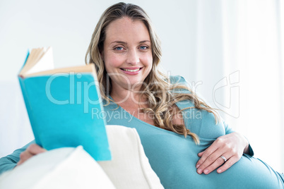 Pregnant woman reading a book