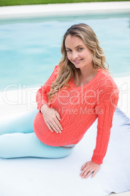 Pregnant woman relaxing outside