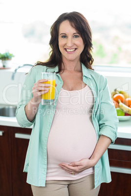 Pregnant woman holding orange juice