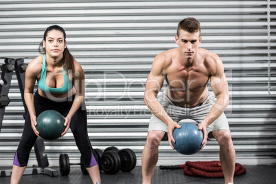 Fit couple doing ball exercise