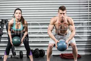 Fit couple doing ball exercise