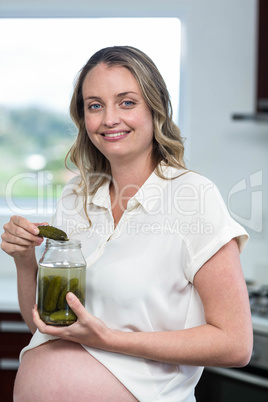 Pregnant woman eating gherkins