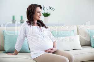 Pregnant woman sitting in the living room