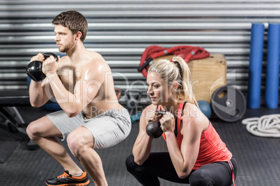 Couple lifting dumbbells together