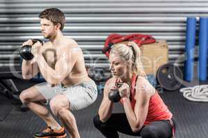 Couple lifting dumbbells together