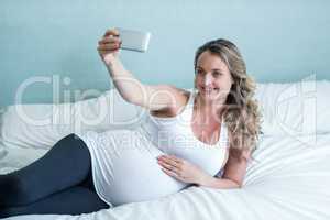 Pregnant woman taking a selfie