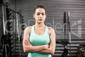 Unhappy athletic woman crossing arms