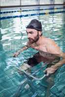 Focused man doing underwater bike