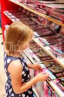 Girl chooses a book in a bookstore