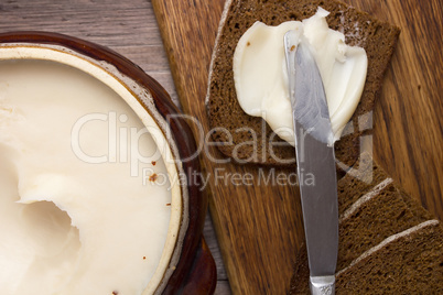 Melted fat and brown bread on chopping board