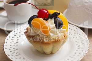 Cake with cream and cherries in a basket