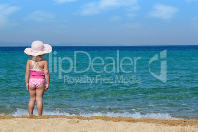 little girl looking at sea