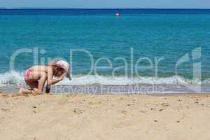 little girl playing on the beach